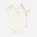 Cream baby onesie with pink heart